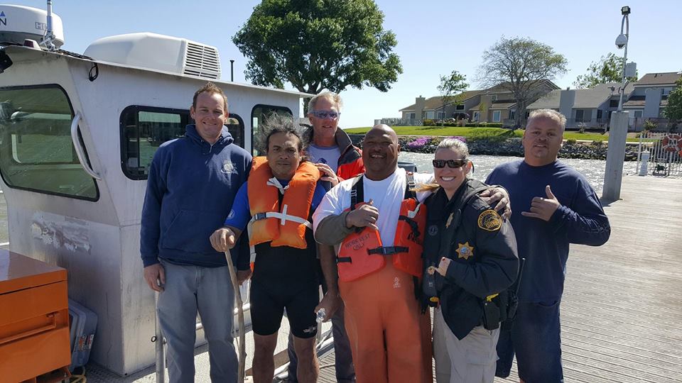 The rescued boater, second from left, with his rescuers from the U.S. Army Corps of Engineers and the Sheriff's Office Marine Services Unit.