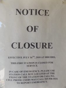 Sign in the window of the closed Discovery Bay fire station.